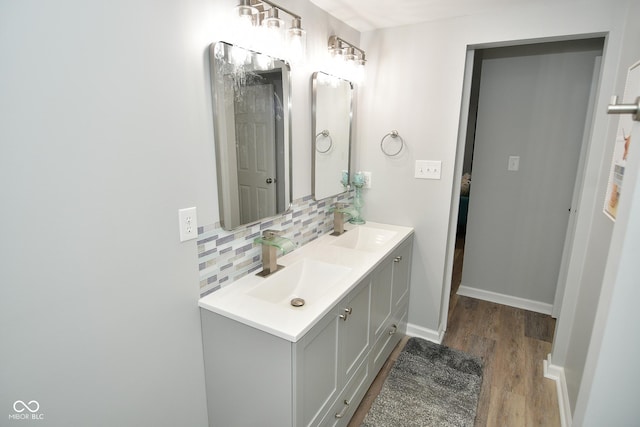 bathroom with backsplash, vanity, and wood-type flooring