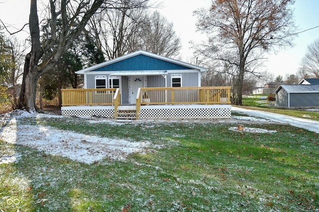 view of front of home with a front lawn and a wooden deck