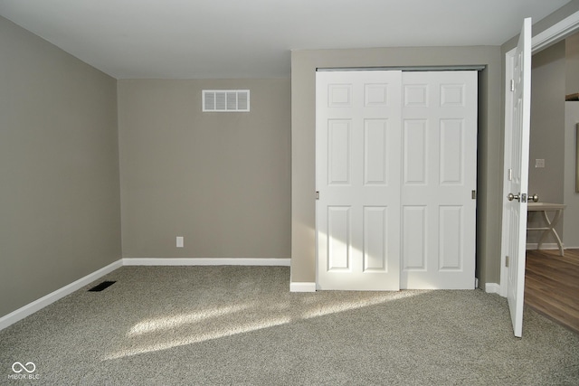 unfurnished bedroom featuring carpet floors and a closet