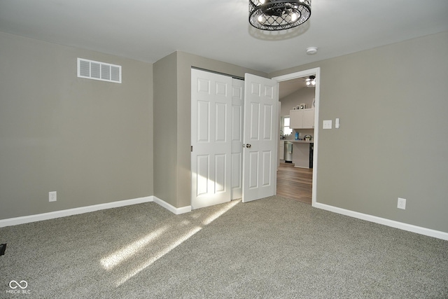 unfurnished bedroom with carpet flooring and a closet