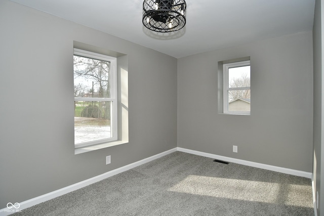 spare room featuring carpet floors and a healthy amount of sunlight