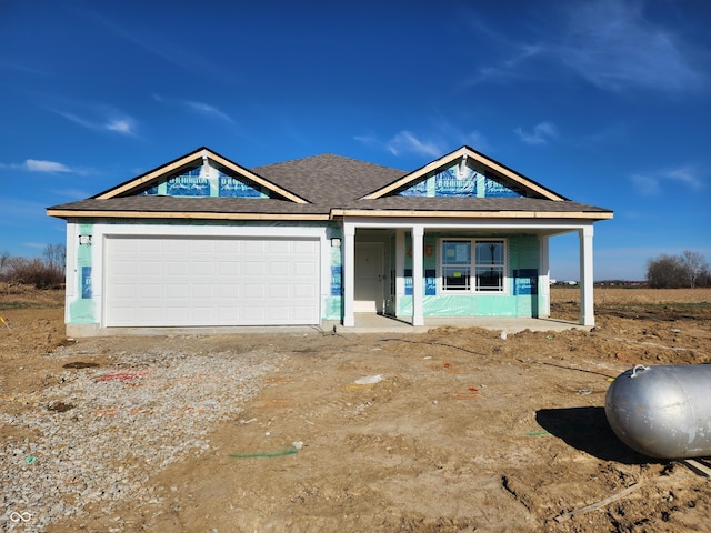 view of front facade with covered porch and a garage