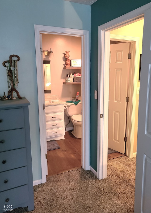 bathroom featuring hardwood / wood-style flooring, vanity, and toilet