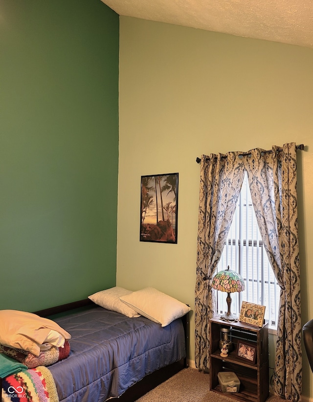 bedroom with carpet and a textured ceiling