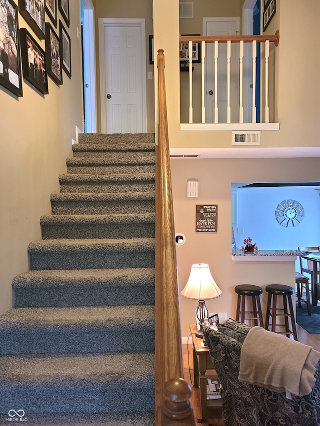 stairway featuring wood-type flooring