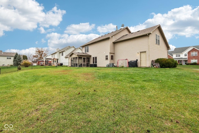 rear view of house featuring a lawn