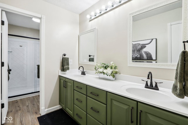 bathroom featuring vanity, wood-type flooring, and walk in shower