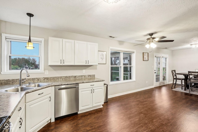 kitchen with sink, white cabinetry, a textured ceiling, appliances with stainless steel finishes, and pendant lighting