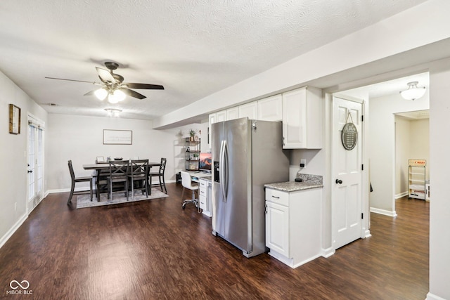 kitchen featuring white cabinetry, a textured ceiling, stainless steel fridge, dark hardwood / wood-style flooring, and ceiling fan