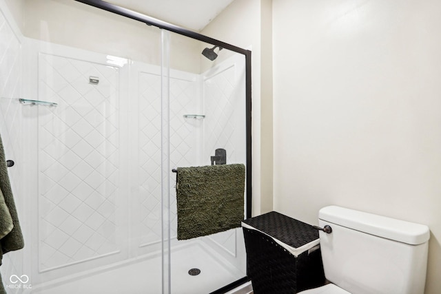 bathroom with a shower with door and toilet