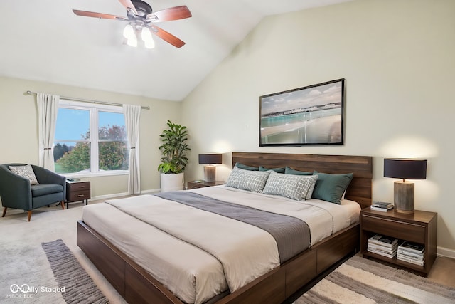 bedroom with lofted ceiling, light colored carpet, and ceiling fan