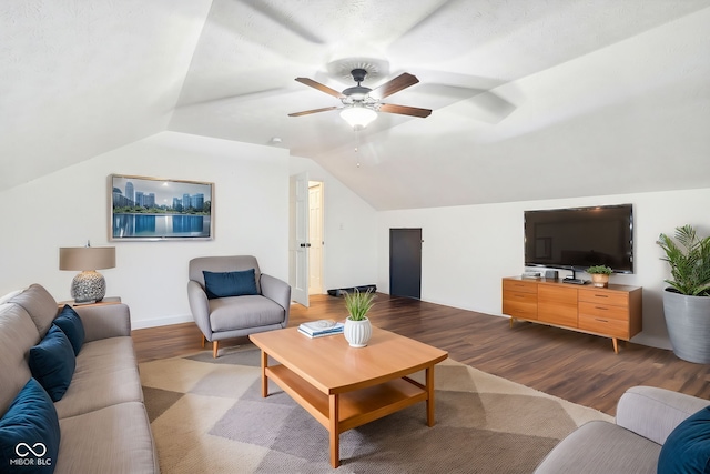 living room with hardwood / wood-style floors, vaulted ceiling, and ceiling fan