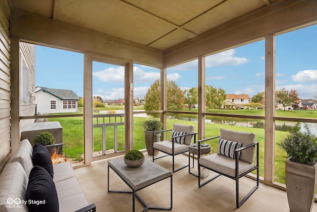 sunroom / solarium featuring a water view and a wealth of natural light