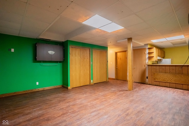 1510 S Greensboro Pike, New Castle, IN 47362 - basement with a paneled ceiling, white refrigerator, and wood-type flooring