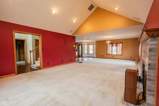 1510 S Greensboro Pike, New Castle, IN 47362 - unfurnished living room featuring carpet floors, high vaulted ceiling, a brick fireplace, and a notable chandelier