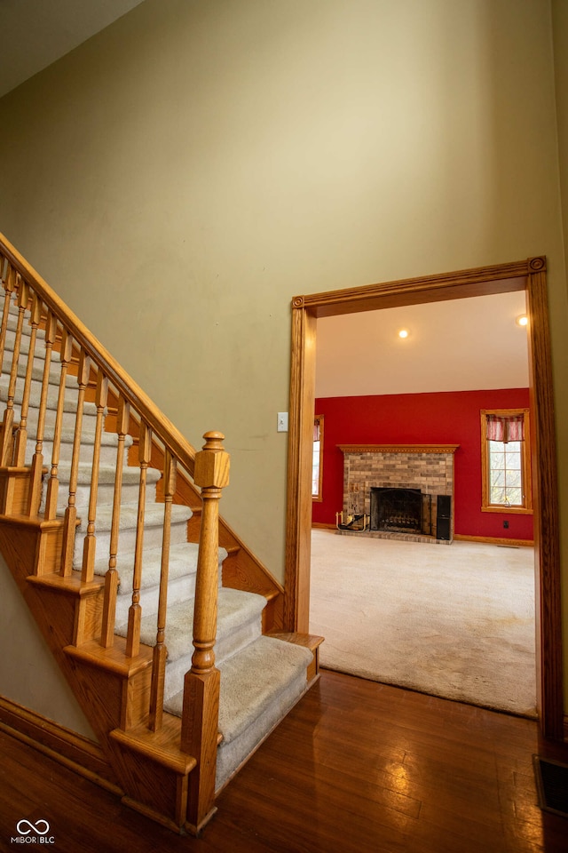 1510 S Greensboro Pike, New Castle, IN 47362 - stairs with hardwood / wood-style floors, lofted ceiling, and a brick fireplace