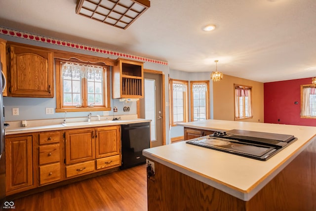 1510 S Greensboro Pike, New Castle, IN 47362 - kitchen featuring a notable chandelier, black appliances, sink, light hardwood / wood-style flooring, and decorative light fixtures