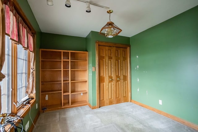 1510 S Greensboro Pike, New Castle, IN 47362 - unfurnished bedroom featuring carpet, a closet, track lighting, and multiple windows