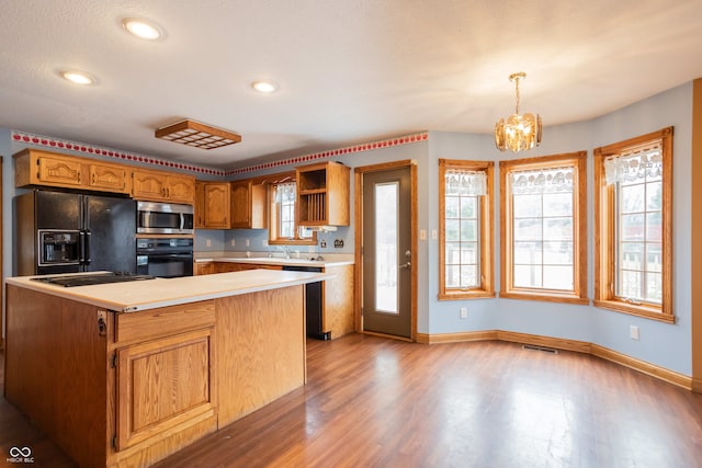 1510 S Greensboro Pike, New Castle, IN 47362 - kitchen with sink, an inviting chandelier, light hardwood / wood-style floors, decorative light fixtures, and black appliances
