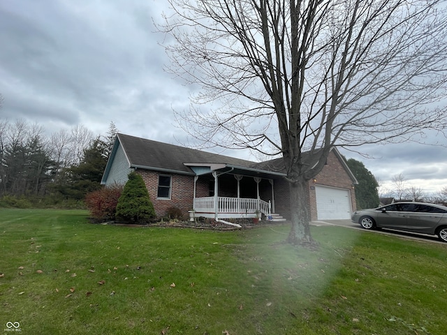 view of front facade featuring a garage, covered porch, and a front lawn