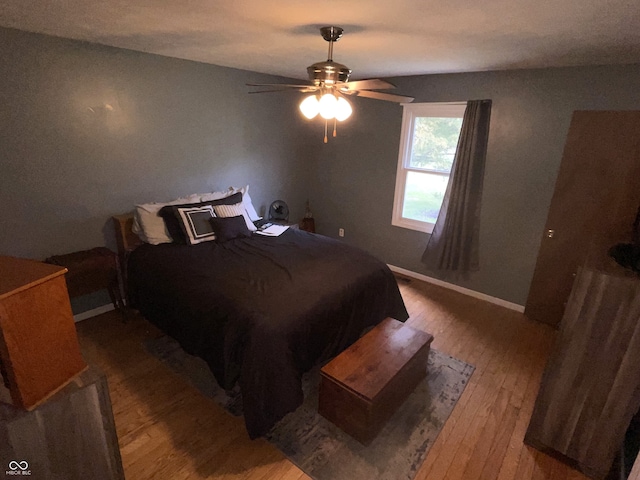 bedroom with ceiling fan and hardwood / wood-style floors