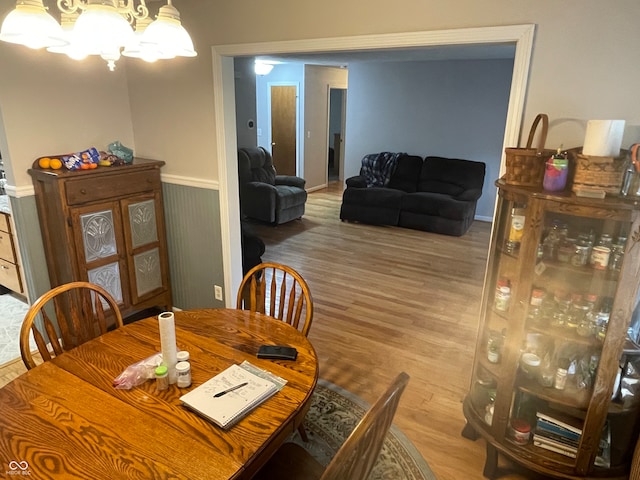 dining space featuring a notable chandelier and hardwood / wood-style flooring