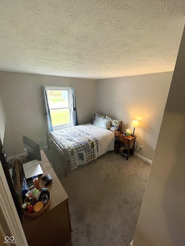 carpeted bedroom featuring a textured ceiling