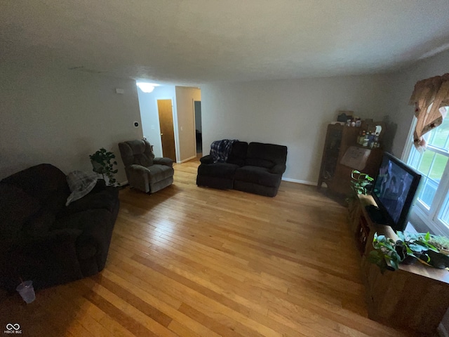 living room featuring a textured ceiling and light hardwood / wood-style floors