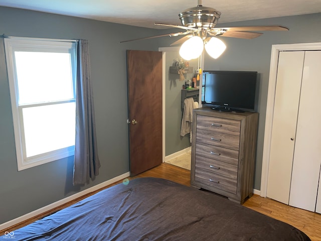 bedroom with ceiling fan and light wood-type flooring