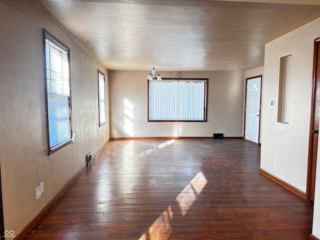 spare room featuring dark wood-type flooring