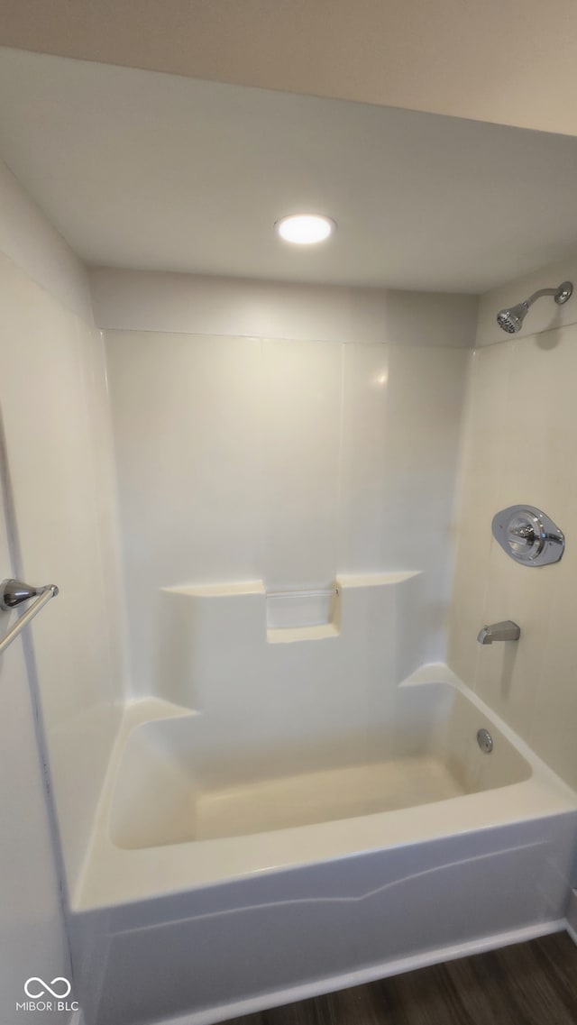 bathroom with shower / bathing tub combination and wood-type flooring