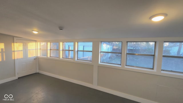 unfurnished room featuring vaulted ceiling