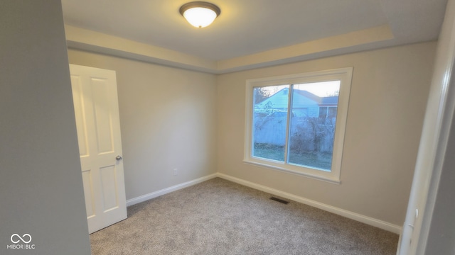 unfurnished room featuring light carpet