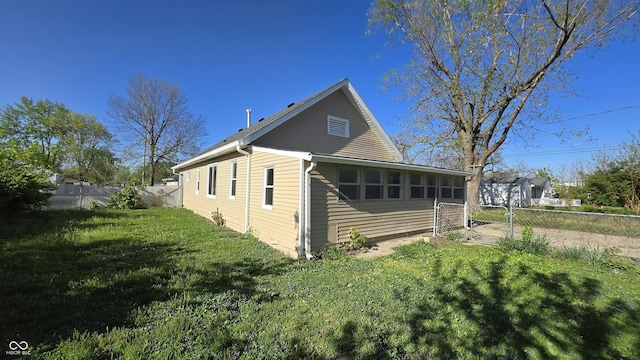 exterior space featuring a lawn, a gate, and fence