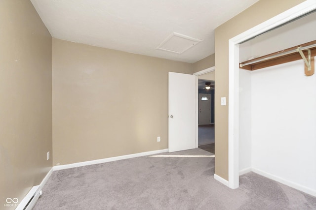 unfurnished bedroom with a closet, light carpet, and a baseboard heating unit