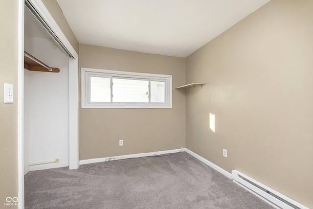 unfurnished bedroom featuring baseboard heating, a closet, and light carpet