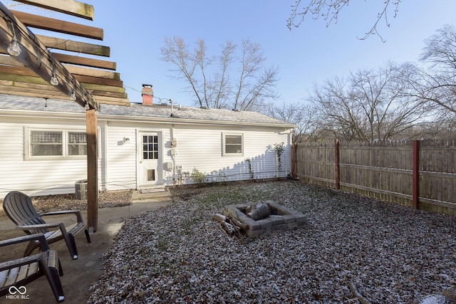 back of house featuring a fire pit and central air condition unit