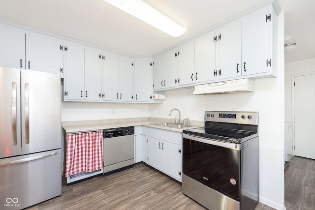 kitchen with dark wood-type flooring, appliances with stainless steel finishes, white cabinetry, and sink