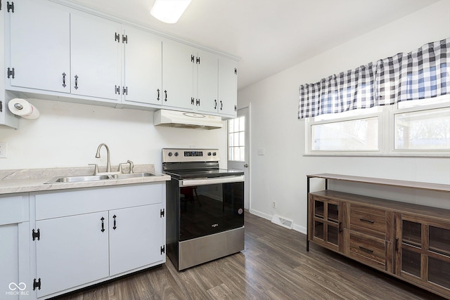 kitchen featuring electric range, dark wood-type flooring, white cabinetry, and sink