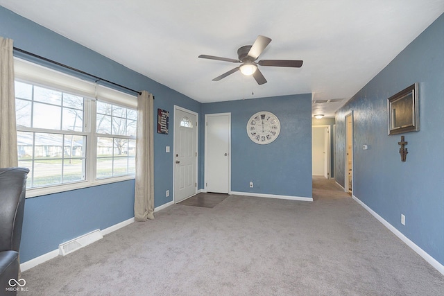 interior space with ceiling fan