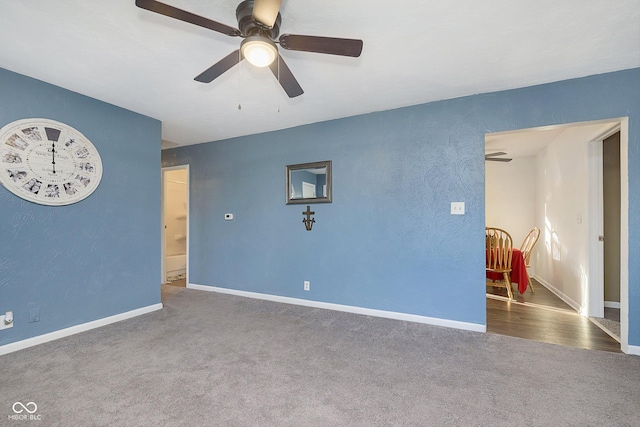 carpeted empty room featuring ceiling fan