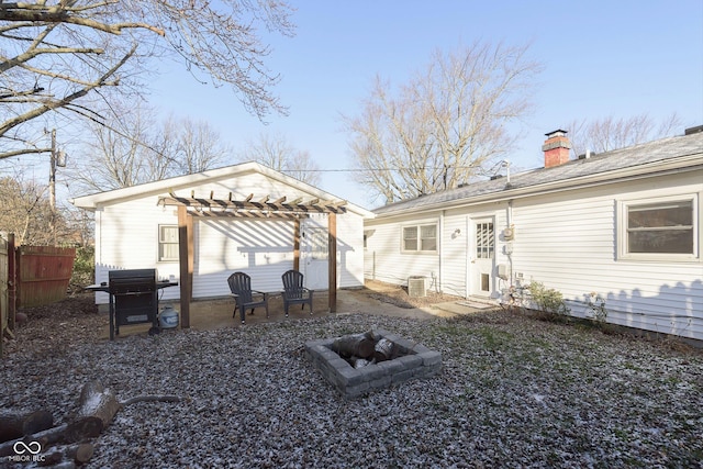 rear view of house with an outdoor fire pit, central AC, a patio area, and a pergola