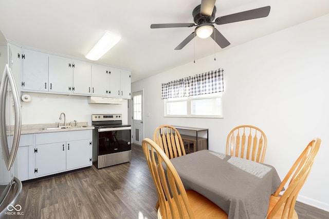 dining area featuring sink, dark wood-type flooring, and ceiling fan