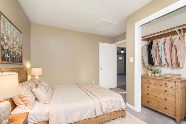 bedroom featuring a closet and light colored carpet