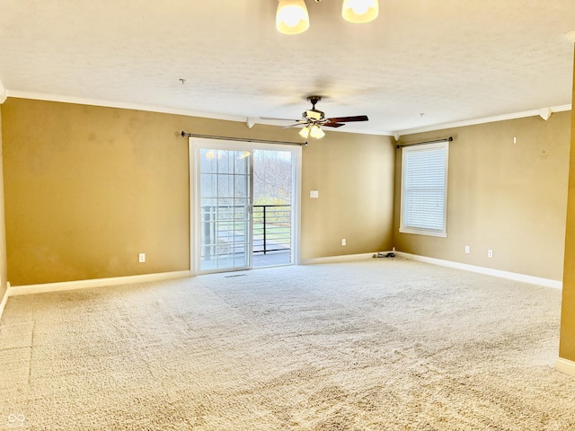 unfurnished room with carpet, a textured ceiling, ceiling fan, and crown molding