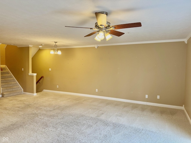 carpeted empty room featuring a textured ceiling, ceiling fan with notable chandelier, and crown molding