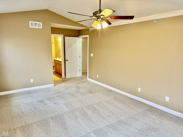 empty room with ceiling fan, light carpet, and vaulted ceiling