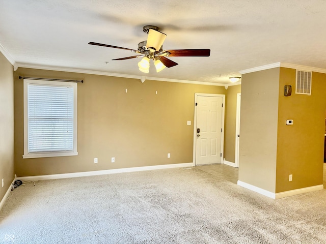 carpeted spare room with ceiling fan, ornamental molding, and a textured ceiling