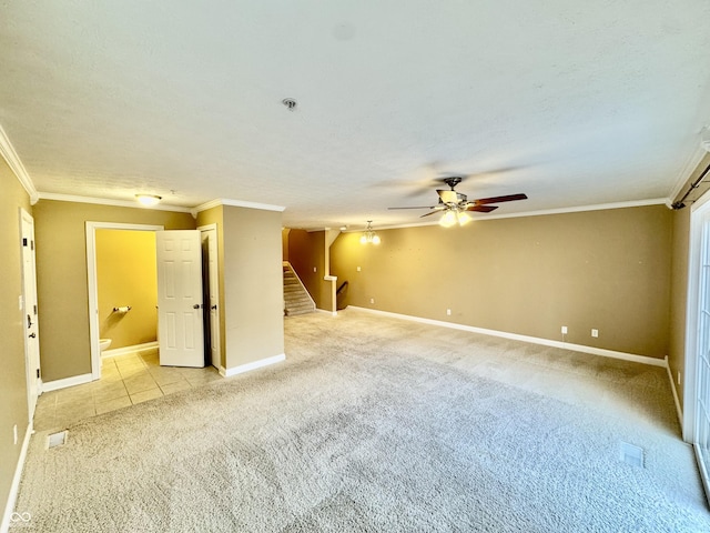 carpeted empty room featuring crown molding, ceiling fan, and a textured ceiling