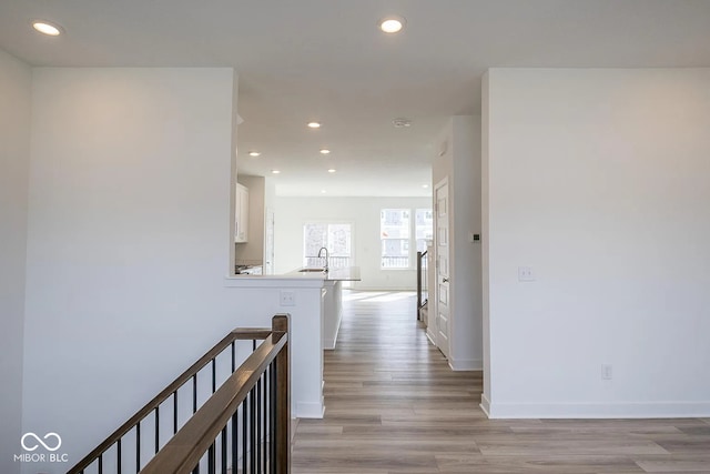 corridor featuring light hardwood / wood-style floors and sink